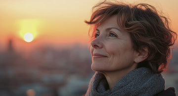 Woman with thinning hair, reflecting on menopause journey.